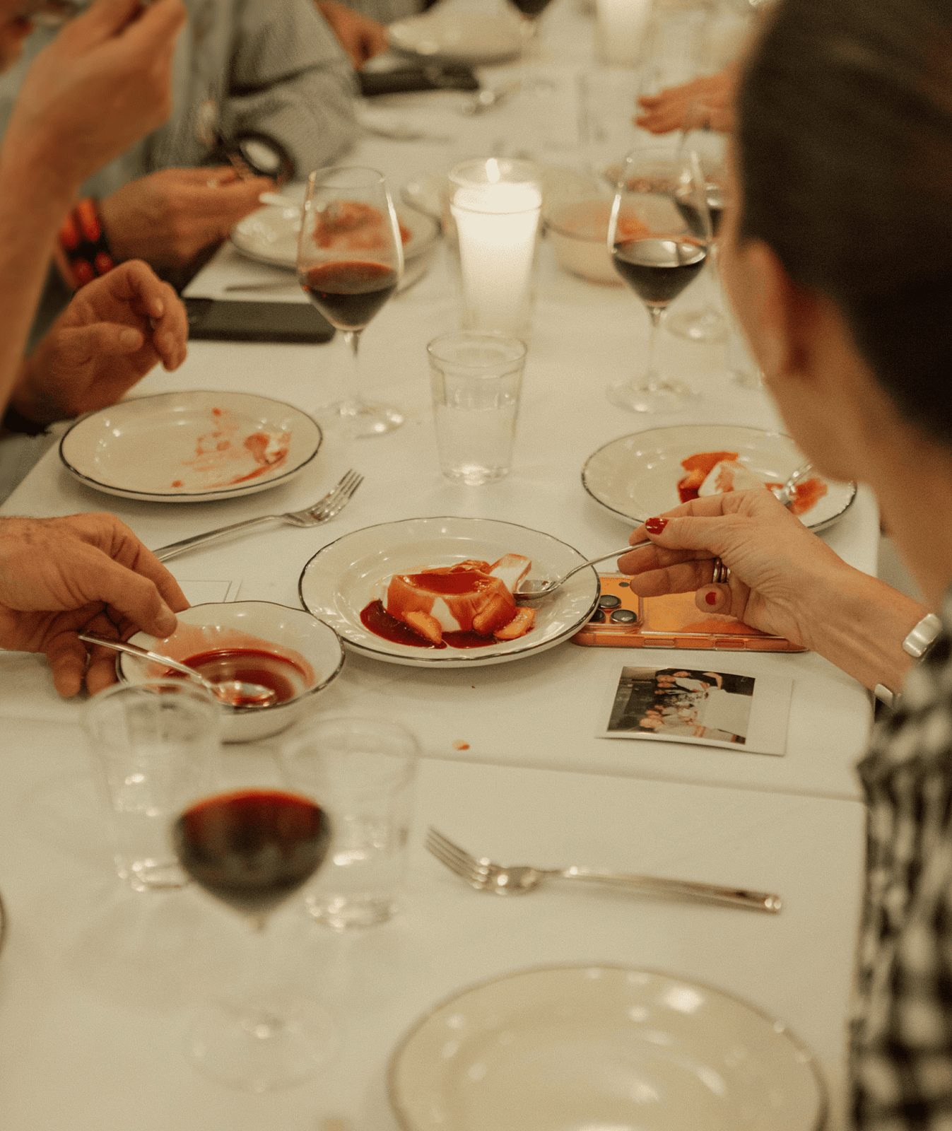 A shared table set with wine glasses and plates at Lalo