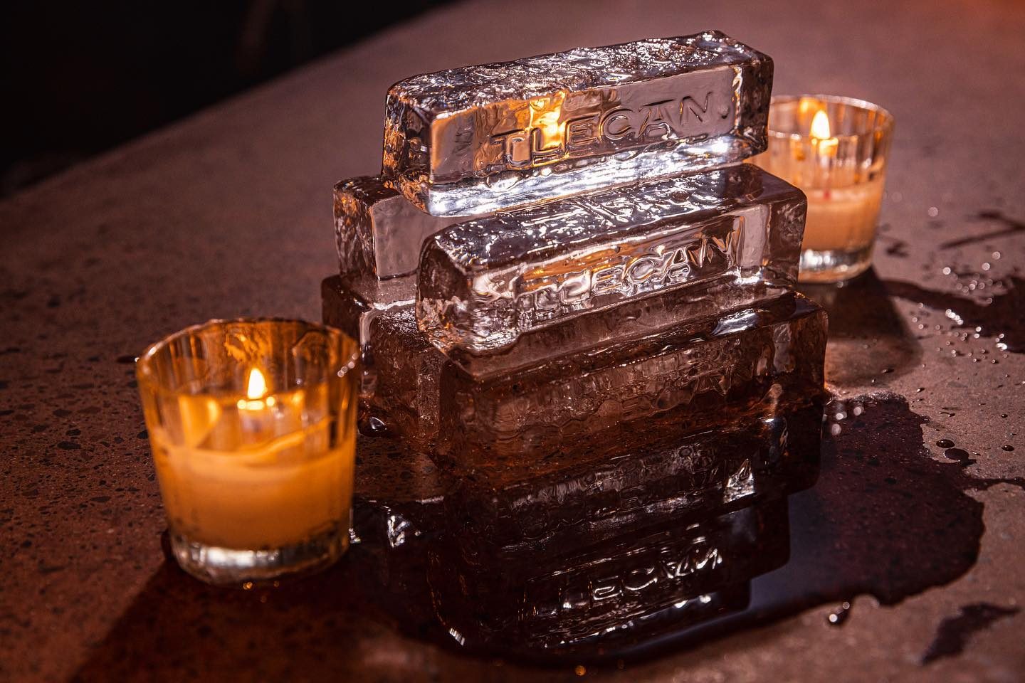 A cocktail served over a carved ice block by candlelight at Tlecán